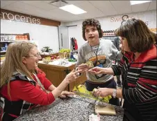  ??  ?? Kenneth Kaufman, 15, who has autism, pays for items in a controlled setting at a miniature ShopRite inside LifeTown, in Livingston, N.J., on March 2.