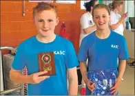  ??  ?? Euan Charlwood and Anna Gemmill, both 11, collecting the swimming club’s award for fourth place.