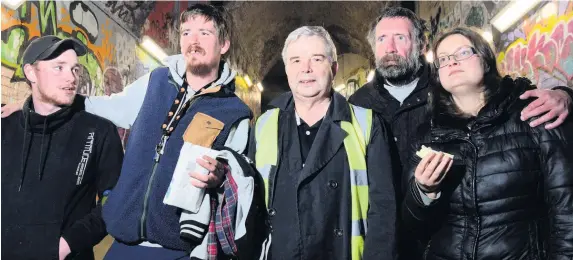 ??  ?? Dai Lloyd, centre, outside Caer Las – Access Point The Strand, Swansea, with some of the homeless benefiting from Bethel Chapel food run