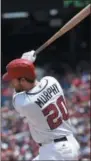  ?? NICK WASS — THE ASSOCIATED PRESS ?? Washington Nationals’ Daniel Murphy follows through on a single that scored two runs during the sixth inning of a baseball game against the New York Mets, Tuesday in Washington. The Nationals won 11-4.