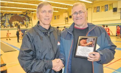  ?? ERIC MCCARTHY/JOURNAL PIONEER ?? West Prince basketball referee Peter Bolo, left, presents his longtime friend and officiatin­g partner, Harvey Mazerolle, with a plaque in recognizin­g his 40-plus years as an official in the sport. Mazerolle retired following the 2019 season.