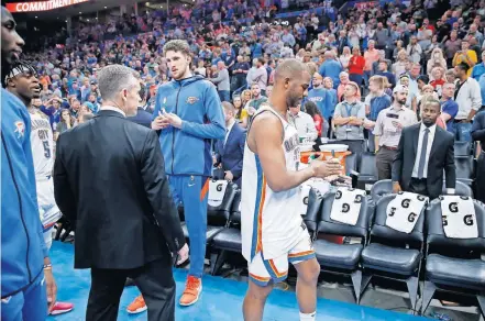  ??  ?? Coach Billy Donovan, Mike Muscala and Chris Paul leave the court with the rest of the team after the Thunder's game against the Jazz was postponed March 11 at Chesapeake Energy Arena. [BRYAN TERRY/ THE OKLAHOMAN]