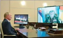  ??  ?? At his residence, Putin talks to his chief of staff via video.