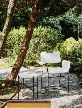  ?? ?? ABOVE Perfect for a shady spot in a townhouse garden, the TS Collection features a tabletop in beautifull­y veined white travertine. Tropique dining chair by Mathieu Matégot, £699; TS outdoor side table by GamFratesi, £599, both Gubi