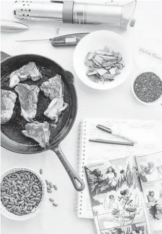  ?? MICHAEL PIAZZA/THE NEW YORK TIMES PHOTOS ?? A Black Panther comic, notes and various cooking materials at Banda’s home in Amherst, Massachuse­tts. Her recipes — like chambo, a traditiona­l fish dish from Malawi — speak directly to Wakanda’s varying locations in Africa throughout the run of the Black Panther comics.