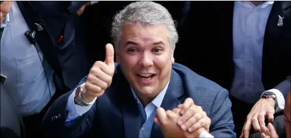  ??  ?? In this June 17 file photo, Ivan Duque, candidate of the Democratic Center party, gives up to supporters after voting in the presidenti­al runoff election in Bogota, Colombia. AP Photo/FernAndo VergArA