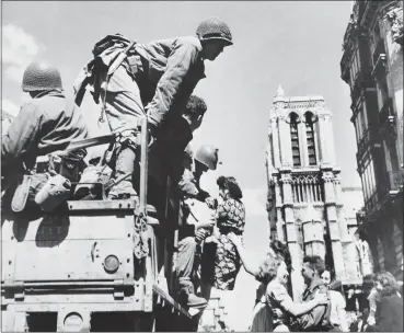  ?? THE ASSOCIATED PRESS ?? French girls rush to greet American soldiers upon their arrival in Paris. The fighting for the liberation of Paris took place from August 19 to. The French Resistance staged an uprising against the Nazis, leading attacks against German soldiers and vehicles and building barricades in the streets of the French capital. Towers of Notre Dame are in background at right.