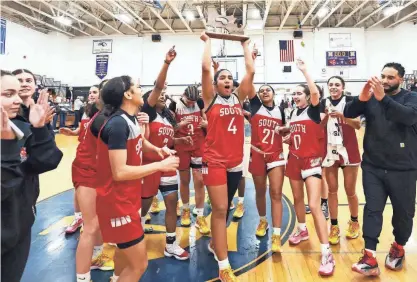  ?? PHOTOS BY MARC VASCONCELL­OS/THE ENTERPRISE ?? South High School players and coaches celebrate at the conclusion of their game against Notre Dame Academy on Saturday at Norwell High.