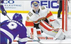  ?? Chris O’meara The Associated Press ?? Panthers goaltender Chris Driedger eyes a shot by Lightning center Tyler Johnson in the second period of Tampa Bay’s 3-2 overtime win Thursday.