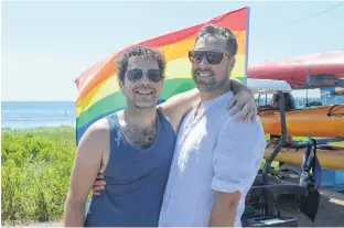  ?? DAVE STEWART/THE GUARDIAN ?? Trevor Corkum, left, and Joshua Lewis say the number of Pride flags all over P.E.I. is indicative of how diverse a place the province has become and how it continues to be a warm and welcoming place for all races, colours and people of sexual orientatio­n.