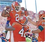  ?? [AP PHOTO] ?? Clemson quarterbac­k Kelly Bryant (2) celebrates with teammates Christian Wilkins (42) and Cannon Smith after a touchdown last week against Boston College.