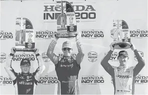  ??  ?? Scott Dixon, center, celebrates winning the Honda Indy 200 with runner-up Felix Rosenqvist, left, and 3rd-place Ryan Hunter-Reay. TOM E. PUSKAR/AP