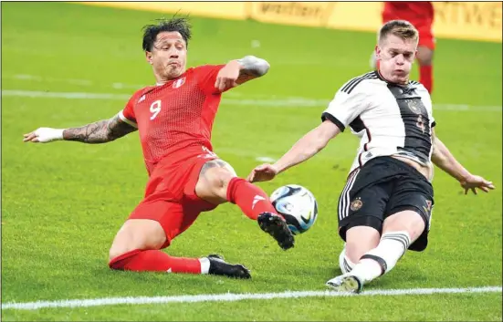  ?? ?? Peru’s Gianluca Lapadula vies for the ball with Germany’s Matthias Ginter, (right), during the internatio­nal friendly soccer match between Germany and Peru at the Opel Arena in Mainz, Germany. (AP)