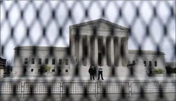  ?? JOSE LUIS MAGANA — THE ASSOCIATED PRESS ?? The U.S. Supreme Court building behind a fence that stood around the building in Washington last month. One proposal in Congress provides additional security for the justices and another offers more privacy and protection for all federal judges.
