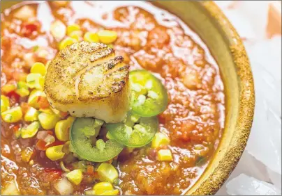  ?? AP PHOTO ?? This recipe for chilled gazpacho soup with sauteed scallops is a simple dish, with little added to enhance the natural flavours of summer vegetables.