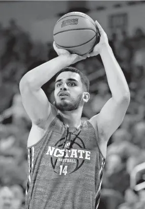  ?? AP Photo/Charlie Riedel ?? ■ North Carolina State center Omer Yurtseven (14) practices for a game Wednesday in Wichita, Kan.