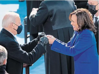  ?? RUTH FREMSON THE NEW YORK TIMES ?? After being sworn in, Vice-president Kamala Harris gives Joe Biden a fist bump at the Capitol in Washington on Wednesday.