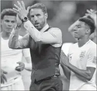  ?? AP PHOTO ?? Beating Belgium on Saturday would give coach Gareth Southgate (middle) and England its best World Cup finish since winning in 1966.