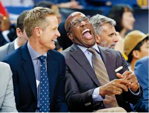  ??  ?? Head coach Steve Kerr laughs with associate head coach Mike Brown on the bench, above. At right, it’s often a similar scene at practice with assistant coach Jason Collins (left) and the close-knit staff.