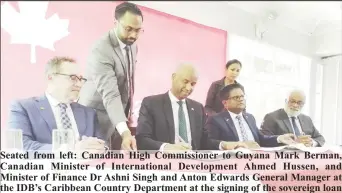  ?? ?? Seated from left: Canadian High Commission­er to Guyana Mark Berman, Canadian Minister of Internatio­nal Developmen­t Ahmed Hussen, and Minister of Finance Dr Ashni Singh and Anton Edwards General Manager at the IDB’s Caribbean Country Department at the signing of the sovereign loan agreement (Antonio Dey)