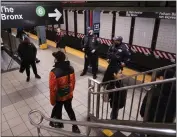  ?? DAKOTA SANTIAGO — THE NEW YORK TIMES ?? NYPD officers stand guard at the subway station on 125th Street and Lexington Avenue in New York City on Monday.