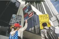  ?? MORGAN LIEBERMAN/NEW YORK TIMES FILE PHOTO ?? Los Angeles parents demonstrat­e against a vaccine mandate in November. To some who are steadfastl­y opposed to the vaccine, the evasivenes­s of COVID-19 has only reaffirmed their stance.