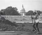  ?? J. SCOTT APPLEWHITE/AP FILE ?? Workers do repairs at a park near the Capitol in Washington. Roadblocks remain in the quest for an infrastruc­ture deal.