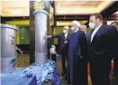  ?? IRANIAN PRESIDENCY OFFICE VIA AP ?? Iranian President Hassan Rouhani (second from right) visits a nuclear exhibition on Saturday.