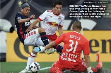  ?? STAFF PHOTO BY JOHN WILCOX ?? DOUBLE-TEAM: Lee Nguyen tumbles over the leg of New York’s Connor Lade as he challenges goalkeeper Luis Robles during the Revolution’s loss last night.