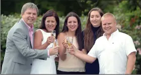  ??  ?? Here’s to us! The family celebrate yesterday after their win