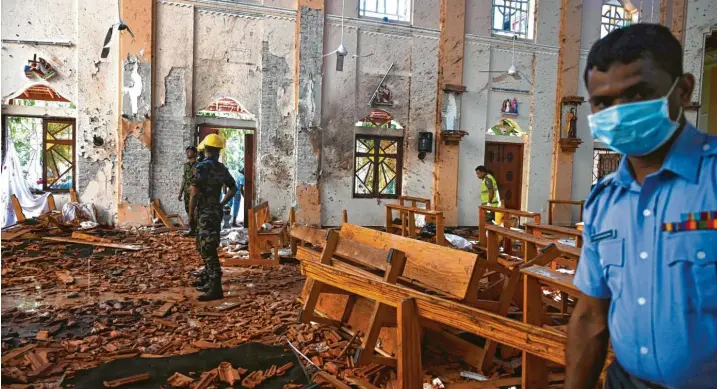  ?? Fotos: Jewel Samad, afp ?? Und dann ist da nur noch Schutt und Tod: Mehr als 1000 Gläubige haben in der St.-Sebastian-Kirche auf Sri Lanka den Ostergotte­sdienst gefeiert, mindestens 102 kamen durch einen Terroransc­hlag ums Leben.