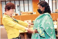  ?? ?? Vice Chair of the Asia Pacific Africa Women’s Economic Exchange summit Mrs Fukuyo Nakamori admires First Lady Dr Auxillia Mnangagwa’s dress made from the national fabric which the mother of the nation spearheade­d as a form of national identity and pride in Tokyo, Japan, yesterday. – Pictures: John Manzongo