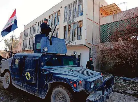  ?? Reuters ?? A vehicle of the Iraqi Special Operations Forces stands guard at the University of Mosul during a battle with Daesh militants in Mosul yesterday.