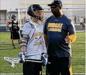  ?? JODIE WAGNER / THE PALM BEACH POST ?? Boca Raton’s Eric Davis (right) stepped down as football coach in December and became an assistant on the school’s JV lacrossete­am.