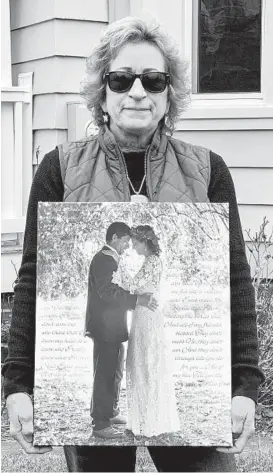  ?? MATT BUTTON/BALTIMORE SUN MEDIA ?? Sharon Fauver, sister of John Raymond Fauver, holds his wedding photograph Monday as she stands in the yard of his home in the 1400 block of Old Pylesville Road in Whiteford.