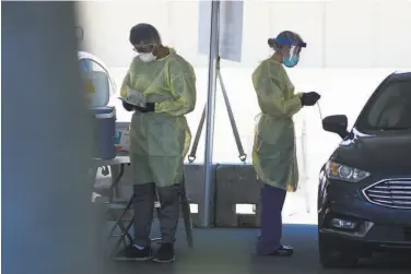  ?? Photos by Kate Munsch / Special to The Chronicle ?? Medical profession­als in May perform Verily COVID19 testing at Allen Temple Baptist Church in East Oakland. Since then San Francisco and Alameda counties have severed ties with Verily for testing sites.