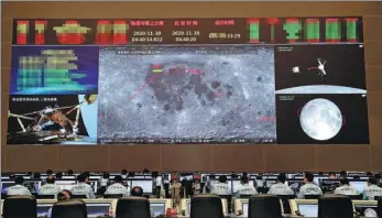  ?? XINHUA ?? Space workers monitor the status of Chang’e 5 at a control center in Beijing on Tuesday.