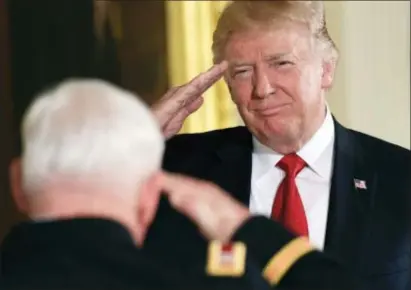  ?? ASSOCIATED PRESS ?? President Donald Trump, right, salutes retired Army Capt. Gary M. Rose, left, before bestowing him with the nation’s highest military honor, the Medal of Honor, during a ceremony in the East Room of the White House in Washington, Monday.