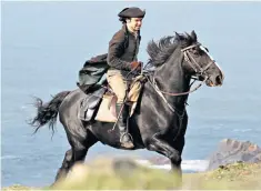  ??  ?? Aidan Turner (Ross Poldark) tests his horse out along a Cornish cliff edge during filming