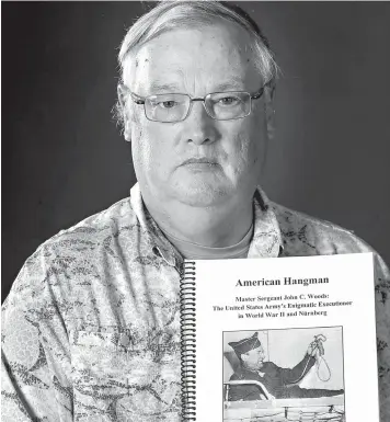  ?? Fernando Salazar/Wichita Eagle/TNS ?? Col. (Ret.) French MacLean with a draft of his upcoming book, "American Hangman," about Master Sgt. John Woods, who was the hangman at the Nuremberg Trials.