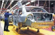  ?? BLOOMBERG ?? Workers assemble vehicles at a Proton factory in Shah Alam, Malaysia.