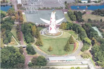  ?? ?? This aerial photo shows the “Tower of the Sun” by Japanese artist Taro Okamoto, which was the symbol of the 1970 Osaka Expo and now the location of the Expo Commemorat­ion Park in Suita, Osaka prefecture, seen during a government sponsored trip above the city.