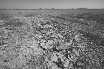  ?? ASSOCIATED PRESS ?? IN THIS SEPT. 30 FILE PHOTO, dry desert soil cracks due to the lack of monsoon rainfall in Maricopa, Ariz. In a report released Thursday, National Oceanic and Atmospheri­c Administra­tion forecaster­s see a dry winter for all of the South from coast-to-coast and say that could worsen an already bad drought.