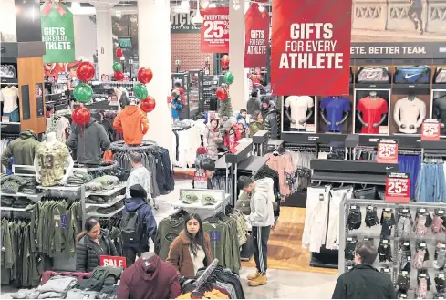  ?? REUTERS ?? People shop inside a Dick’s Sporting Goods store during a sales event on Thanksgivi­ng day in Westbury, New York.