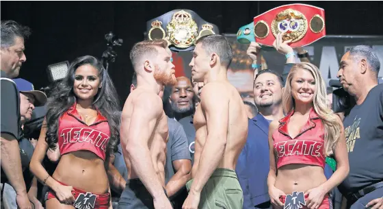  ??  ?? Canelo Alvarez, centre left, and Gennady Golovkin face off during the weigh-in on Friday.
