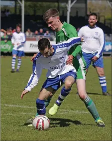  ??  ?? Keith Cogley of Kiltealy Celtic puts pressure on Thomas Brady of Enniscorth­y United.