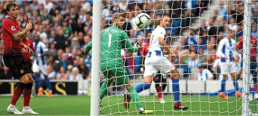  ?? GETTY IMAGES ?? Deft touch: Brighton striker Glenn Murray flicks the ball past United’s David De Gea for the opening goal
