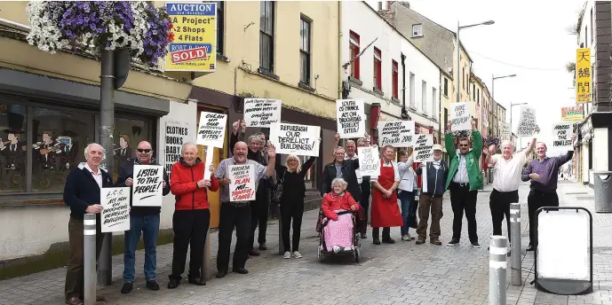  ??  ?? Frank Godfrey leading a protest obout the state of the buildings on Narrow West Street.