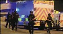  ?? PETER BYRNE — PA VIA AP ?? Armed police work at Manchester Arena after reports of an explosion at the venue during an Ariana Grande gig in Manchester, England Monday.