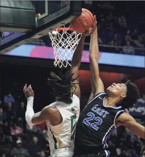  ?? Matthew Brown / For Hearst Connecticu­t Media ?? East Catholic’s James Jones blocks a shot attempt by Notre Dame-West Haven in the Division I final on March 20 at the Mohegan Sun Arena in Uncasville.